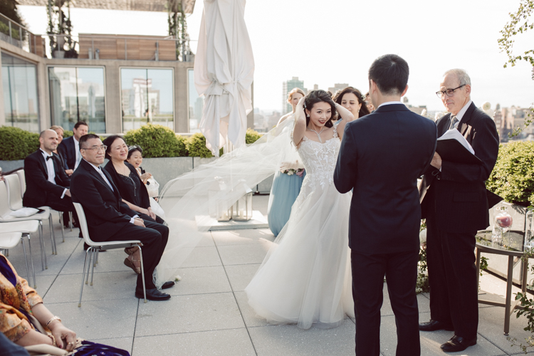 Public Hotel NYC spring rooftop wedding with Stella and Peter. NYC began to loosen COVID restrictions so events and weddings were finally allowed. Stella and Peter were able to keep their original wedding date, but unfortunately Stella's parents couldn't make it to the wedding due to COVID travel restrictions. Stella and Peter's wedding took place on 17th floor with rooftop access at the Public Hotel. Their wedding ceremony was on the rooftop, as well as their first look and some photos then we wandered around the hotel and took some epic photos at the pent house and escalator. Public Hotel NYC was so fun to photograph and I had the coolest, the most chill couple to work with. Stella and Peter's epic wedding at Public Hotel NYC photographed by Karis | Hey Karis.
